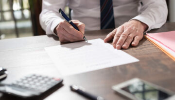 Businessman signing a document