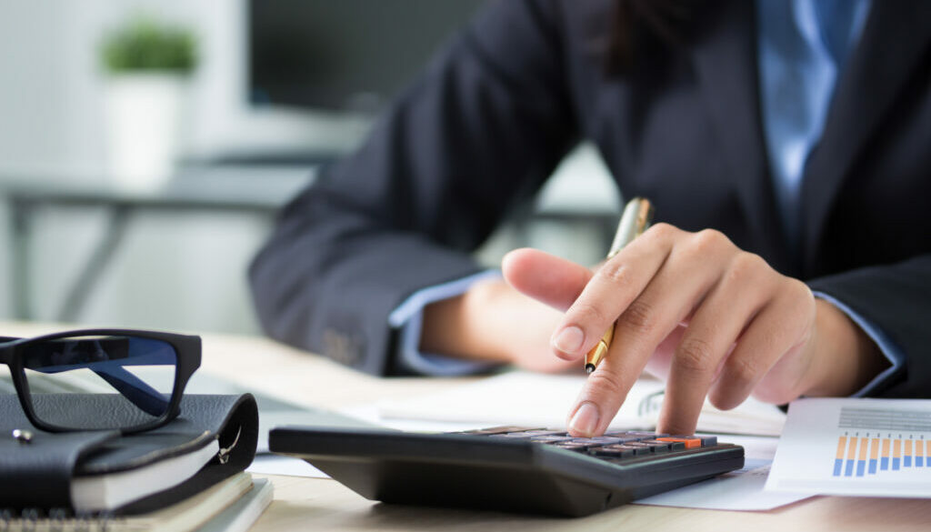 Financial adviser working with client, calculating and analyzing